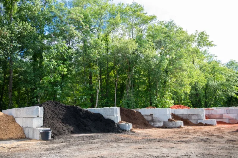 Bulk mulch piles labeled hemlock and red cedar ready for delivery